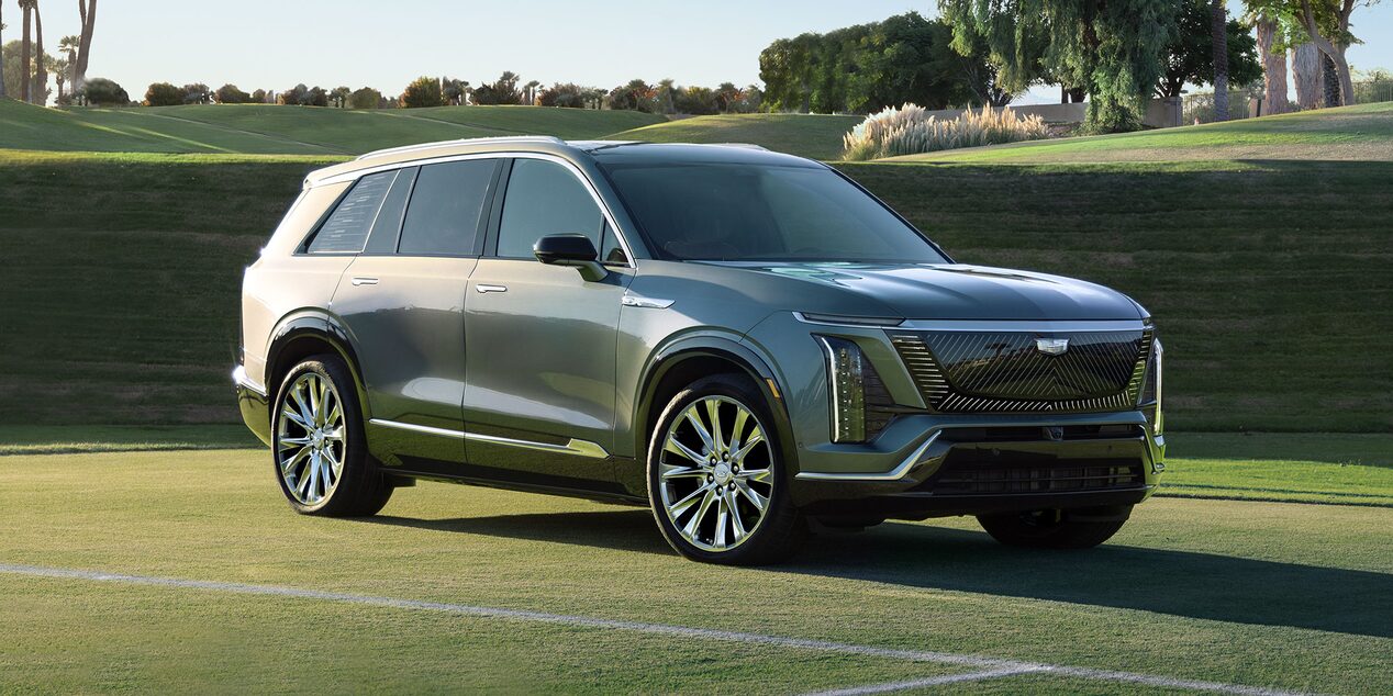 Three-quarters View of a 2026 Cadillac VISTIQ Parked on a Grassy Tennis Court