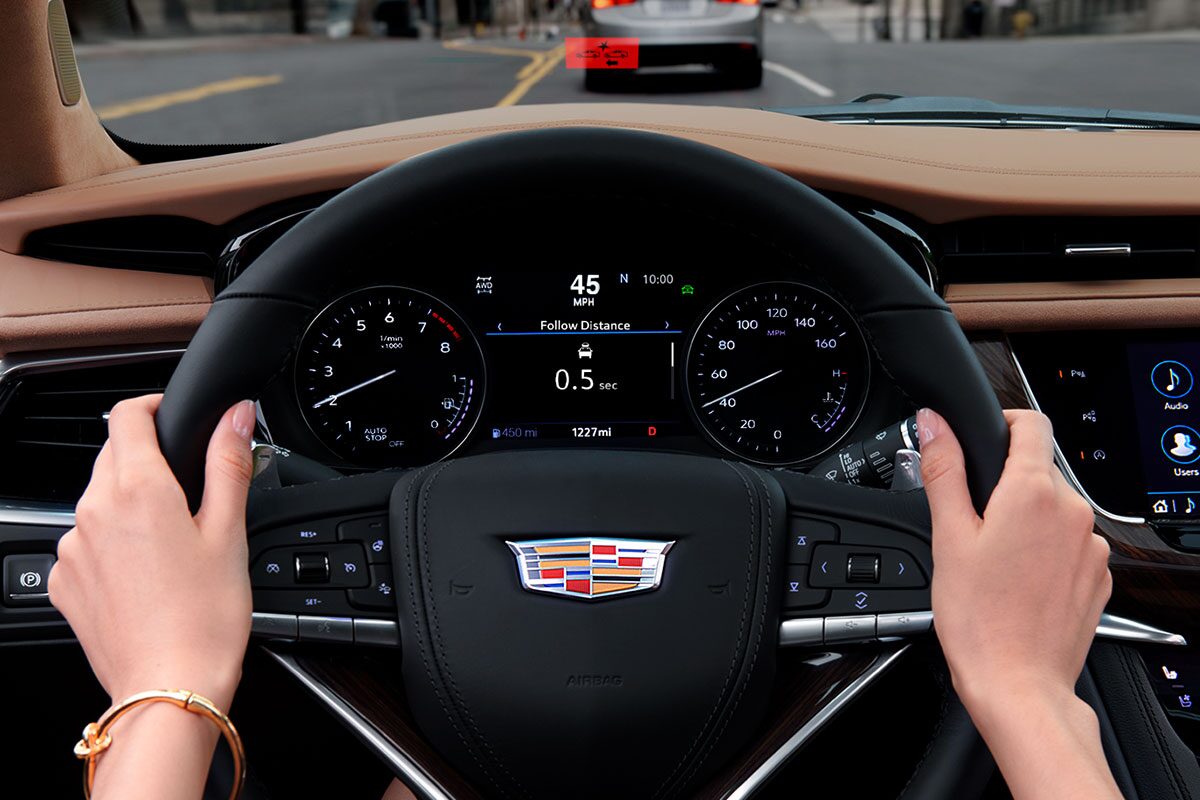 A Woman Uses Both Hands to Hold the Steering Wheel of the Cadillac XT6
