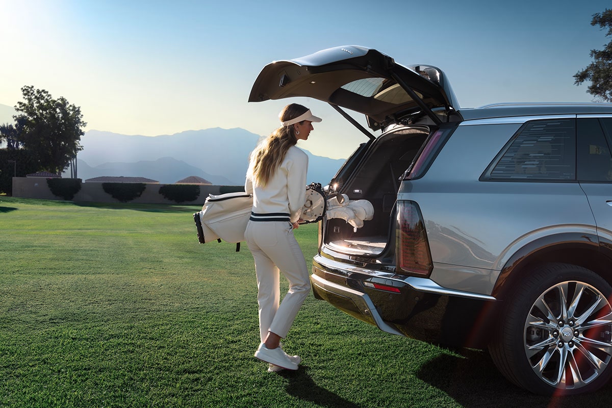 A Woman Putting Her Golf Bag in the 2026 VISTIQ Spacious Trunk