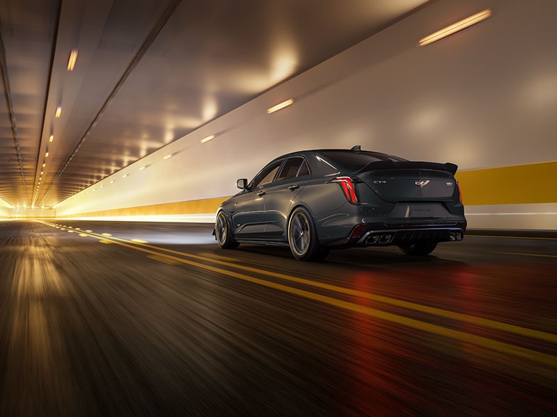Rear View of a Yellow Cadillac CT4-V Driving Through a Tunnel