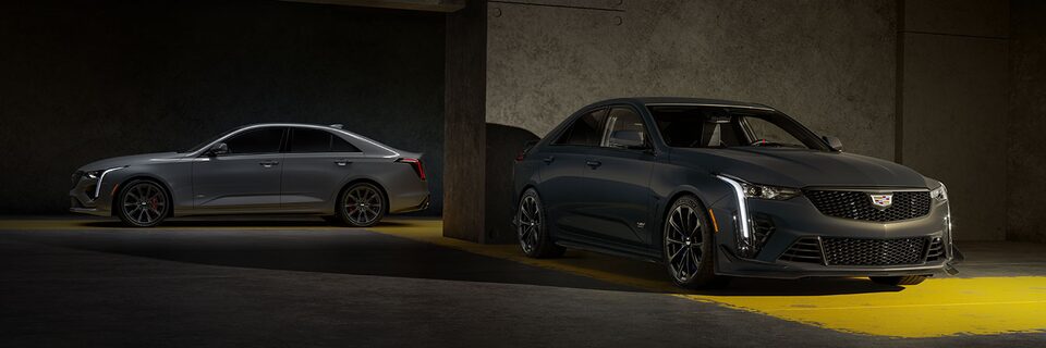 A Silver CT4-V and a Yellow CT4-V Blackwing Parked in a Parking Garage