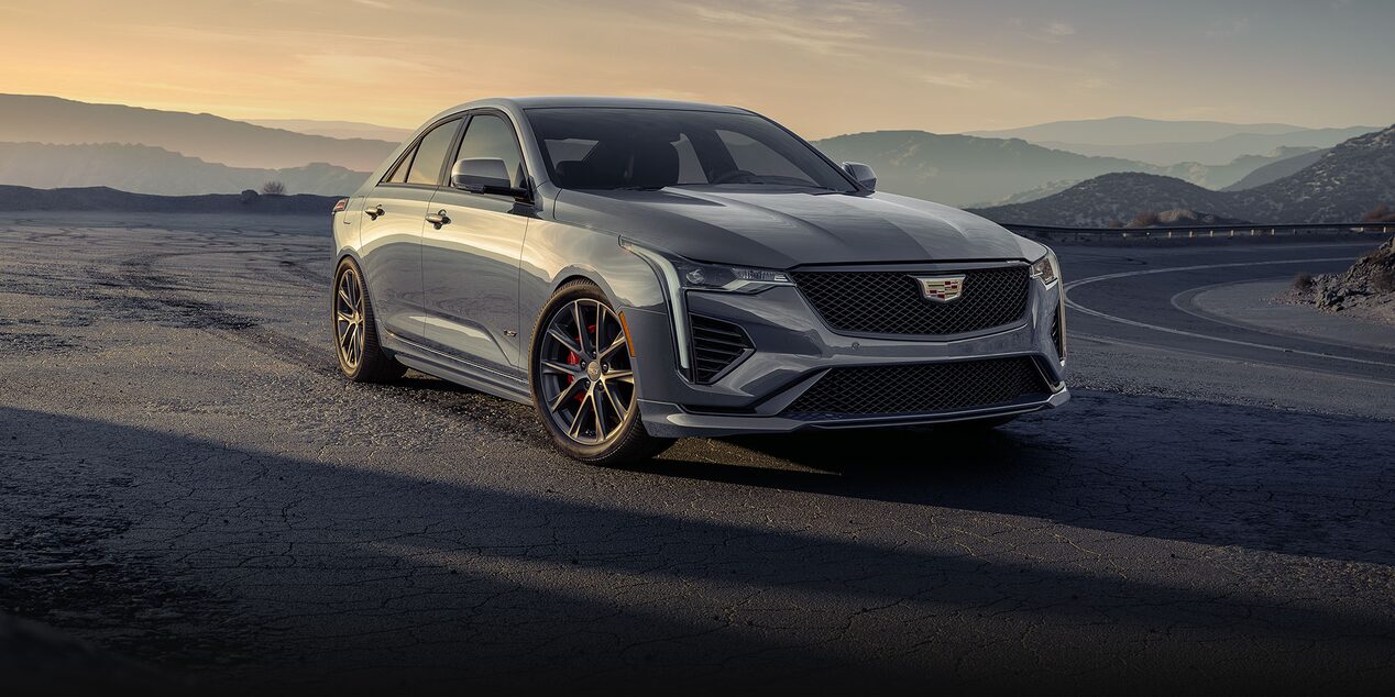 Three-quarter View of a Silver 2024 Cadillac CT4-V Parked on the Side of a Mountain Road