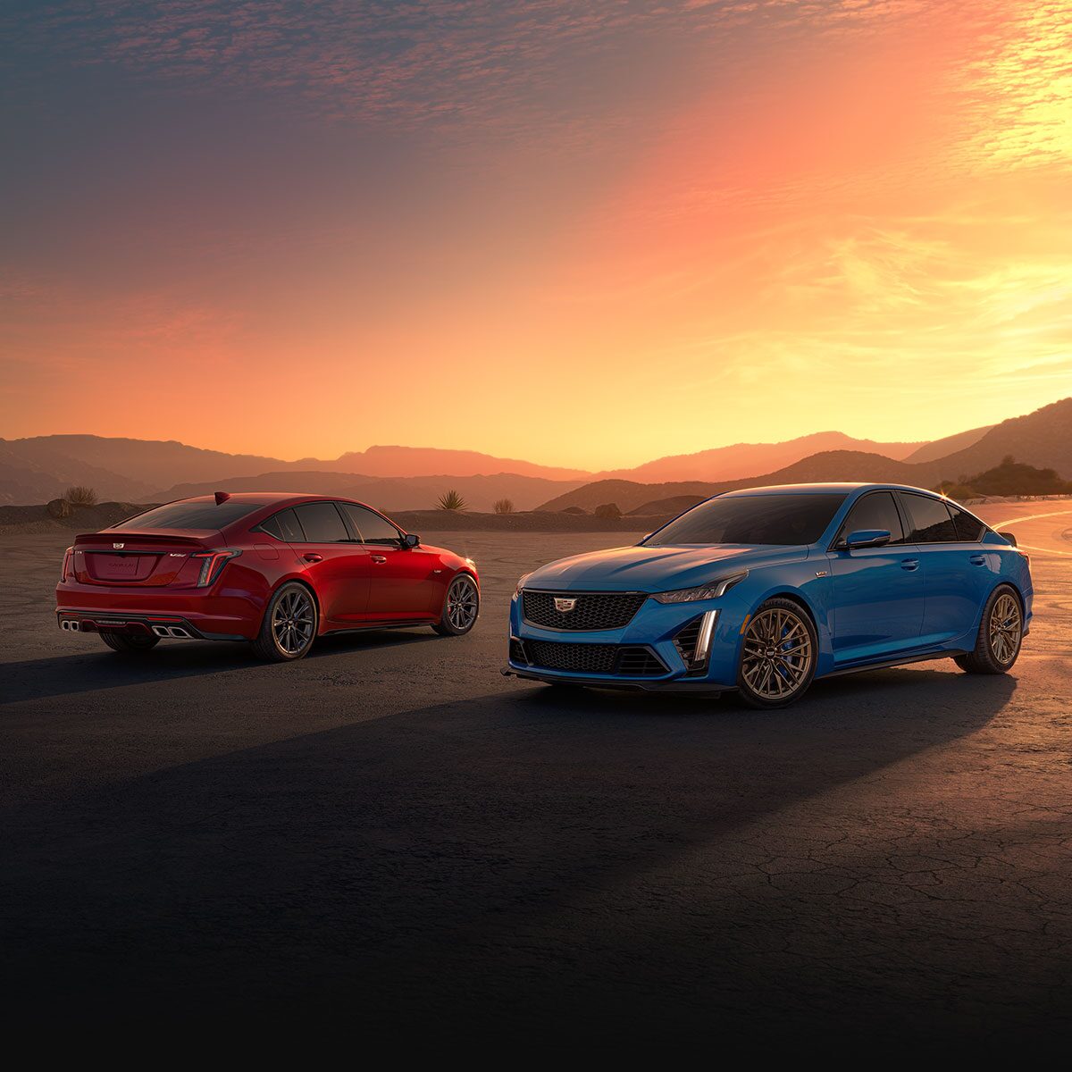 Two 2024 Cadillac CT5-V Sedans Parked in the Desert Under an Evening Sky